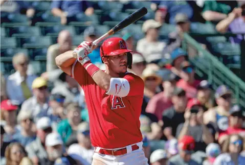  ?? ASSOCIATED PRESS FILE PHOTOS ?? The Angels’ Mike Trout bats against the Mariners during the third inning of a spring training game March 4 in Tempe, Ariz. Major League Baseball has proposed a sliding scale of salary cuts for a pandemic-delayed season.