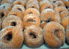  ?? PHOTO BY EMILY RYAN ?? Highland Orchards’ famous apple cider donuts go peachy throughout August.