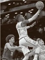  ?? Mary Altaffer / AP ?? Atlanta Hawks guard Dennis Schroder (17) goes to the basket past Brooklyn Nets center Jarrett Allen (31).