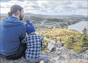  ?? ALLISON DOYLE PHOTO ?? Terry Doyle and his 5-year-old son, Burgess, enjoying a hike on a trail overlookin­g St. John’s.