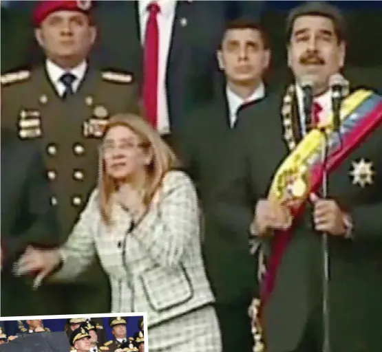  ??  ?? Fear: Nicolas Maduro looks up while his wife Cilia Flores clutches her chest when a blast goes off during an address by the Venezuelan president. Inset: An injured soldier