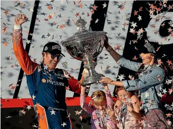  ?? GETTY IMAGES, PHOTOSPORT ?? Scott Dixon won his fifth Indycar championsh­ip in 2018 after Born Racer had been filmed; above, Born Racer revels the close bonds that Scott Dixon has with wife Emma and daughters Poppy and Tilly; below, Dixon started his racing career on go-kart tracks all over New Zealand.
