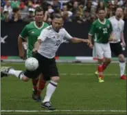  ?? REBECCA BLACKWELL — THE ASSOCIATED PRESS ?? Germany’s Thomas Hassler, front, blocks Mexico’s Ramon Ramirez as they vie for the ball during a pair of “revenge” matches between former pro players from the Mexican and German national soccer teams in the Zocalo, Mexico City’s main square, Sunday,...