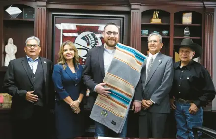  ?? THE IOWA TRIBE OF OKLAHOMA ?? Jake Keyes, center, shown being sworn in as vice chairman of the Iowa Tribe of Oklahoma, launched Skydance Brewing in 2018. The company is one of only 0.4% of craft breweries owned by Indigenous people.