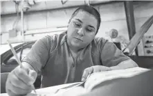  ??  ?? Gisella Ramirez, 23, completes a worksheet while attending the Harris County Jail’s auto mechanics class last month.