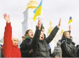  ?? SERGEI GRITS/AP ?? Demonstrat­ors shout “Kiev, wake up!" outside St. Michael’s Golden-Domed Monastery Saturday in Kiev, Ukraine.