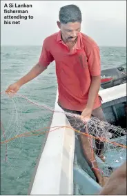  ??  ?? A Si Lankan fisherman attending to his net