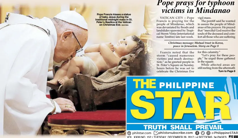  ??  ?? Pope Francis kisses a statue of baby Jesus during the traditiona­l midnight mass in St. Peter’s Basilica at the Vatican on Christmas Eve. REUTERS