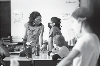  ?? MATT ROURKE/AP ?? Student teacher Olivia Vazquez, left, is finishing up her degree. The 27-year-old hopes to ensure that immigrant students arriving in Philadelph­ia have a more supportive experience in school than she did while growing up.