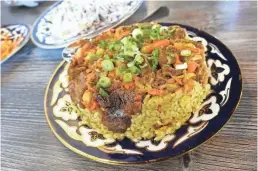  ??  ?? Uzbek plov with beef, rice, carrots and chickpeas at Cafe Chenar in Phoenix.