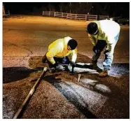  ?? JIM NOELKER / STAFF ?? Montgomery County Water personnel work on a valve under Shourp Mill Road late on Wednesday. A large water main break cut water service to much of the county and most of it was restored by Thursday morning, but continued to require boiling before use.