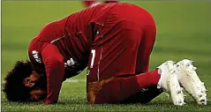  ??  ?? RED RELIEF: Salah kisses the turf after ending his drought by scoring the only goal of the game at Huddersfie­ld