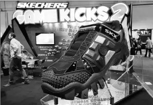  ?? AP ?? Visitors pass by the Skechers’ booth at the Internatio­nal Consumer Electronic­s Show in Las Vegas in January 2016.