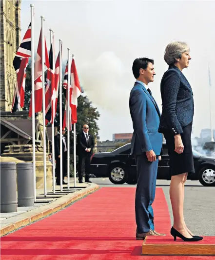  ??  ?? Theresa May is placed on a pedestal so she can stand level with Justin Trudeau, the Canadian Prime Minister, for a photocall (top left) after she arrived in Ottawa, Ontario, yesterday