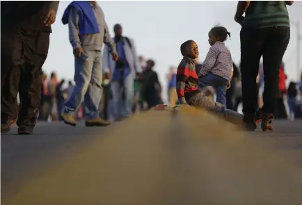  ??  ?? Children and others mark the 50th anniversar­y of “Bloody Sunday” on the Edmund Pettus Bridge in March 2015 in Selma, Ala.