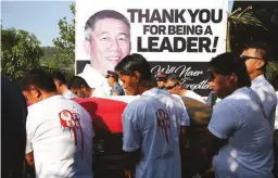  ??  ?? FAREWELL, MAYOR — The casket of Mayor Alexander O. Buquing of Sudipen, La Union is taken to the public cemetery in Barangay Castro, Sudipen for burial yesterday. The mayor who was slain last October 1 is survived by his wife, Vice Mayor-turned-Mayor Wendy Joy Buquing, and their children. (Erwin G. Beleo)