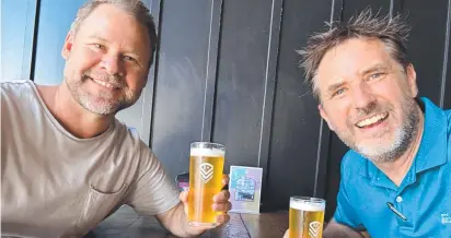  ?? ?? Division 13 candidate Josh Martin and Mudgeeraba-based councillor Glenn Tozer enjoy a cold one after checking the election vote count.