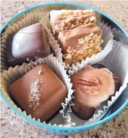  ??  ?? A tin full of fudge and specialty chocolate from ChocGlitz &amp; Cream is the perfect gift.