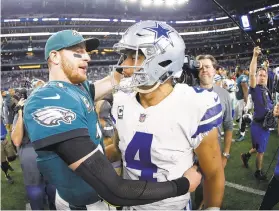  ?? RON JENKINS/AP ?? Dak Prescott (right) and the Cowboys saved their season with a win in Philadelph­ia a month ago. Now Carson Wentz and the defending champion Eagles are trying to do the same in Texas against first-place Dallas on Sunday.