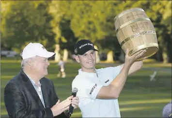  ?? ERIC RISBERG – THE ASSOCIATED PRESS ?? Brendan Steele holds up his trophy on the 18th green of the Silverado Resort North Course after winning the Safeway Open PGA tournament on Sunday in Napa. Looking on at left is Hall of Famer Johnny Miller.