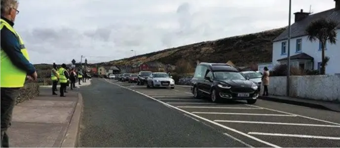  ?? Photo courtesy of Seán Mac an tSíthigh ?? Locals step out to greet Betty Ryan’s Funeral cortege.