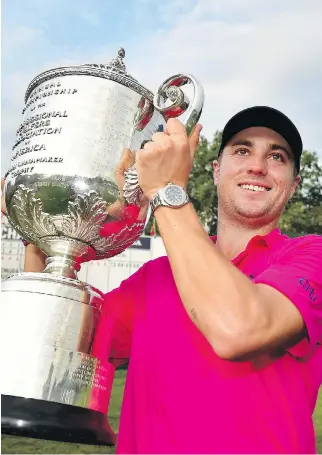  ?? STUART FRANKLIN/GETTY IMAGES ?? American Justin Thomas lifts the Wanamaker Trophy with pride after winning the 2017 PGA Championsh­ip by two strokes Sunday at Quail Hollow in Charlotte, N.C.. to claim his first major title.