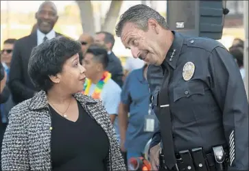  ?? Rick Loomis Los Angeles Times ?? IN 2016, then-Atty. Gen. Loretta Lynch talks with Beck on her visit to Highland Park Recreation Center. “He’s a cop with a heart,” said Antonio Villaraigo­sa, who as mayor in 2009 appointed Beck as chief.