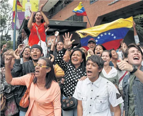  ??  ?? HAVE FAITH: Supporters of Venezuelan evangelica­l pastor and presidenti­al pre-candidate Javier Bertucci shout as he leaves a news conference in Caracas.