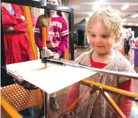  ??  ?? Right: Five-yearold Lucy Collier from Neerim South is fascinated by the Harmonogra­ph machine, which uses a system of swinging weighted pendulums to draw a pattern. No two patterns are ever the same. This process is what is used to make bank notes;...