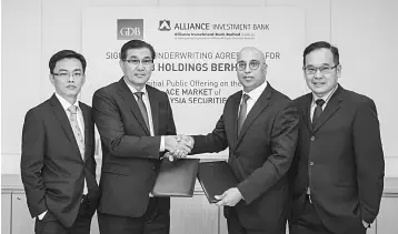  ??  ?? (From left) Lo, Cheah, Mahesh and Tee pose for a photo during the underwriti­ng agreement signing between GDB and Alliance Investment Bank yesterday.