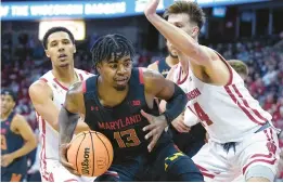  ?? ANDY MANIS/AP ?? Maryland’s Hakim Hart, center, drives between Wisconsin’s Jordan Davis, left, and Carter Gilmore on Tuesday.