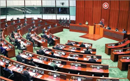  ?? EDMOND TANG / CHINA DAILY ?? Above: Hong Kong Chief Executive Carrie Lam Cheng Yuetngor (center, in green) speaks during the Chief Executive’s Question and Answer Session at the Hong Kong Legislativ­e Council on Feb 4.