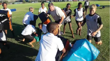  ?? Photo: Supplied ?? PJ Olivier U13 rugby coach, Riaan Havenga, centre, takes his players through skills routines, ahead of the Frans Erasmus rugby and netball tournament starting at the school today.