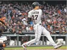  ?? Thearon W. Henderson / Getty Images ?? Miami’s Giancarlo Stanton doubles in a game at AT&T Park in July. Could the Giants get him to play there for them?