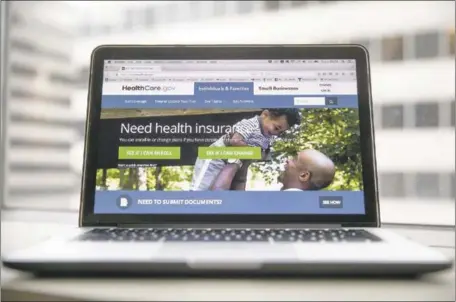  ?? MARK THIESSEN — THE ASSOCIATED PRESS ?? The HealthCare.gov website where people can buy health insurance is seen on a laptop computer screen. The GOP failed to repeal the law.