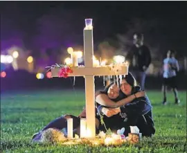  ?? Gerald Herbert Associated Press ?? ON THE THIRD anniversar­y of the Parkland school shooting, President Biden said “the time to act is now” on gun control. Above, a 2018 candleligh­t vigil.