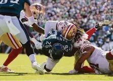  ?? Andy Lewis / Icon Sportswire via Getty Images ?? Niners middle linebacker Fred Warner tackles Eagles running back Miles Sanders during a second-quarter goal-line stand.