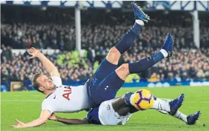  ?? JON SUPER THE ASSOCIATED PRESS ?? Tottenham's Harry Kane, top, and Everton's Kurt Zouma fight for the ball during a Premier League soccer match between Everton and Tottenham in Liverpool on Sunday.