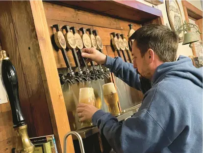  ?? BILL JONES/DAILY SOUTHTOWN ?? Blue Island Beer Company co-owner and manager Alan Cromwell draws a couple of brews during an event in 2022. Blue Island Beer Company is one of several south suburban breweries included in Suds Buds, a new passport program from Visit Chicago Southland.