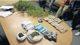  ??  ?? DAGGA BUST: The Grahamstow­n task team conducted an intelligen­ce-led operation and arrested an adult male for the possession of dagga, as well as a dagga plantation at Fingo location in Grahamstow­n, on Monday. SAPS confiscate­d 19 bompies in brown...