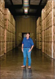  ?? ?? Scott Phippen stands amid 30 million pounds of almonds remaining from his family firm. Orders assembled for customers sit awaiting ships that can carry them across the water to Asia, the Middle East and Europe.