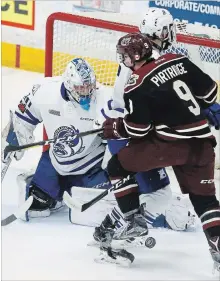  ?? CLIFFORD SKARSTEDT EXAMINER ?? Peterborou­gh Petes rookie callup Jake Partridge is checked off the puck by Mississaug­a Steelheads’ Stephen Gibson in front of goalie Jacob Ingham during OHL action on Thursday at the Memorial Centre.