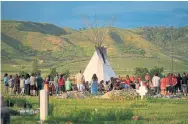  ?? GEOFF ROBINS AFP VIA GETTY IMAGE FILE PHOTO ?? Hundreds gather for a vigil in a Saskatchew­an field where human remains were discovered. Indigenous reconcilia­tion is top of mind to many voters.