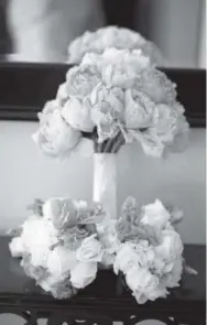  ?? Courtesy of dreamstime. com ?? double- duty florals: Wedding bouquets are expensive. Get the most out of them by repurposin­g them at the reception to accessoriz­e the cake or guestbook table.