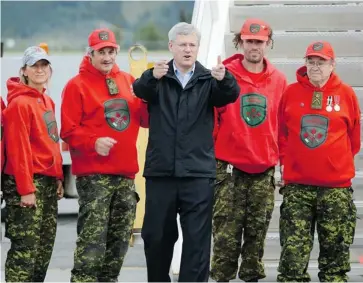  ?? SEAN KILPATRICK/THE CANADIAN PRESS ?? If Prime Minister Stephen Harper — shown with Canadian Rangers in Whitehorse on Sunday — can convince Northerner­s that his model of economic developmen­t can work, it would be a political plum, says Michael Den Tandt.