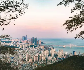  ??  ?? Above: A view over Busan’s Suyeong District and the Gwangandae­gyo suspension bridge. Below: Exploring Yeongdo island’s Huinnyeoul Culture Village. Bottom: An establishm­ent in the Jeonpo Café Street area.