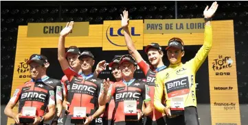  ?? — AFP photo ?? Australia’s Richie Porte (left), Belgium’s Greg Van Avermaet (right), wearing the overall leader’s yellow jersey and their teammates of USA’s BMC Racing cycling team celebrate on the podium after winning the third stage of the 105th edition of the Tour de France cycling race, a 35.5 km team time-trial around Cholet, western France.