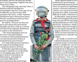  ??  ?? A riot police officer stands guard with roses given to him by protesters in Yangon, Myanmar, where the military junta has placed heavy restrictio­ns on the internet and social media