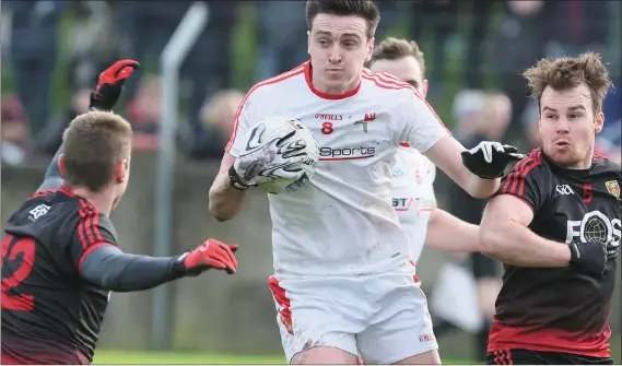  ??  ?? Down’s Caolan Mooney and Darragh O’Hanlon keep the pressure on Louth’s Tommy Durnin. Picture: Paul Connor