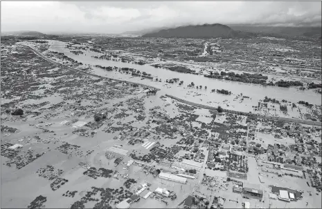  ?? JAPAN NEWS-YOMIURI ?? An aerial photo Sunday shows a flooded residentia­l area of Nagano, Japan after a dike of the Chikuma River was breached.